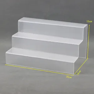 Clear acrylic 3-tier display shelf organizer for cosmetics, figures, and retail products.