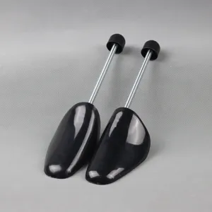 Black plastic shoe trees with metal springs, adjustable shoe stretchers to prevent deformation.