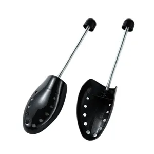 Black plastic shoe trees with metal springs and ventilation holes for shoe anti-wrinkle.