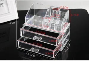 Clear acrylic makeup organizer box with drawers and multiple compartments for desktop storage.