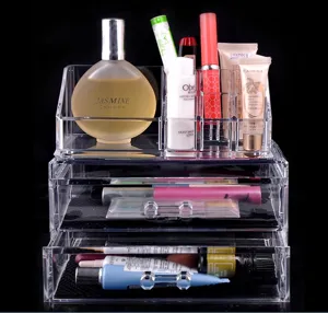 Clear acrylic cosmetic organizer with drawers and top slots for makeup and jewelry storage