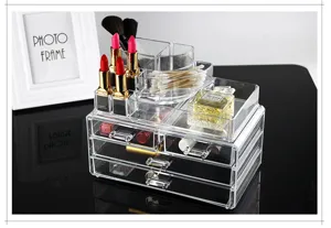 Clear acrylic makeup organizer detail showing multi-compartment desktop storage and drawers.
