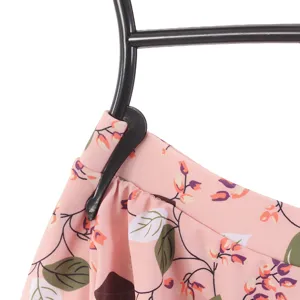 Black plastic swimsuit hanger detail, close-up clip design for underwear and garments.