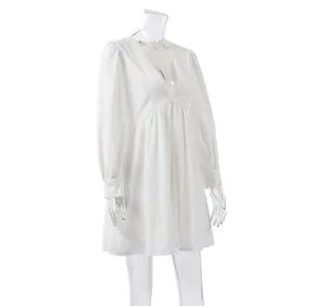 White long sleeve V-neck dress detail view showing the elegant bubble sleeves and loose hem.