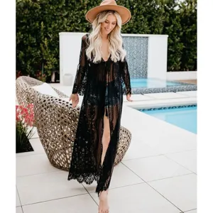Detailed view of a stunning black lace long beach cover-up cardigan worn poolside.