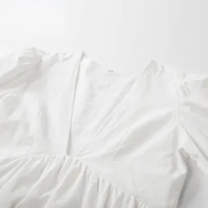 White dress detail, deep V-neck, elegant puff sleeves, gathered high waist, soft fabric.