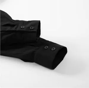 Black long sleeve dress shirt cuff detail with double buttons on clean white background