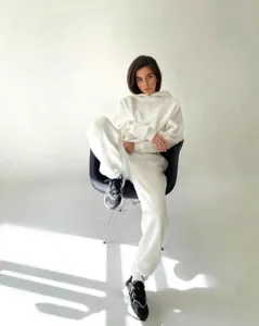 Detail view of the casual long sleeve hoodie and sweatpants set worn by model in studio.