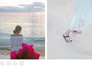 Detailed view of white bohemian off-shoulder summer beach dress with delicate lace embroidery.