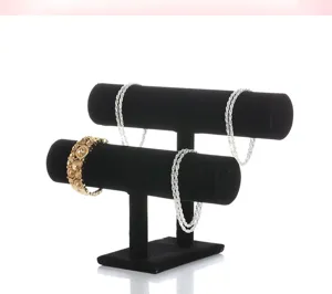 Detailed view of a black velvet two-tier jewelry display stand for bracelets, bangles, and watches.