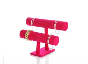 Pink velvet double layer jewelry display stand for bracelets and bangles in store.