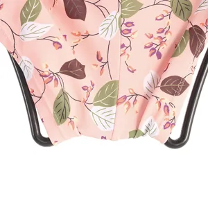 Detailed view of women swimsuit hanging on a black display rack with pink floral fabric pattern.