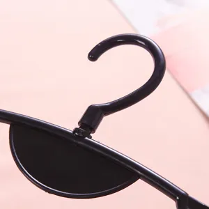 Black plastic swimsuit hanger hook close-up view, ideal for women swimwear retail display.