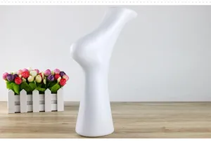 Detailed view of white plastic foot mannequin, perfect for sock and shoe photography props.