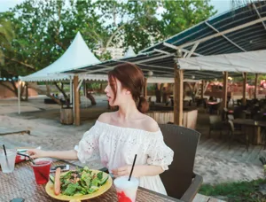 White off-shoulder bohemian dress, elegant beach vacation wear with delicate lace details.