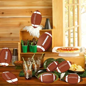 Football party supplies set with themed plates, cups, and cutouts for game day decor.