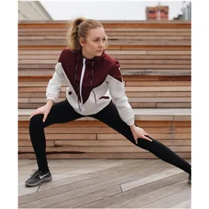 Women's color-blocked hooded windbreaker jacket, featuring a stylish maroon and white design.