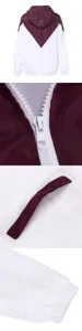 Women colorblock hooded jacket detail showcasing zipper pocket and elastic cuff design.