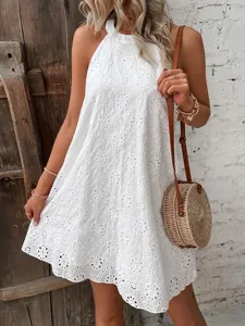 Summer women's white halter sleeveless eyelet dress with round straw bag fashion style.