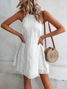 Details of the women white summer sleeveless halter eyelet dress with embroidery.