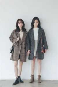 Detail view of the classic plaid woolen coat showcasing texture and styling scene.