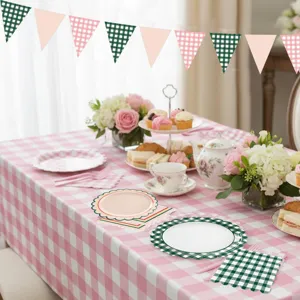 Detail scene of pink and green plaid party tableware and table runner decoration.