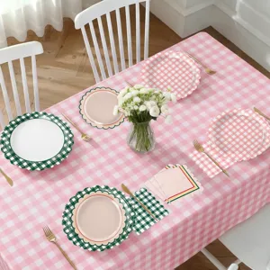 Gingham party tableware detail showing pink tablecloth, decorative plates, and table decor.