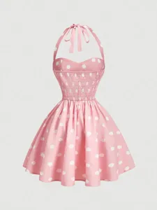 Pink polka dot halter dress detail, sweetheart smocked bodice and flared mini skirt style.