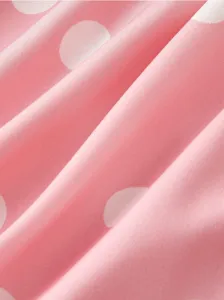 Pink polka dot fabric detail texture close up for women clothing material surface soft design