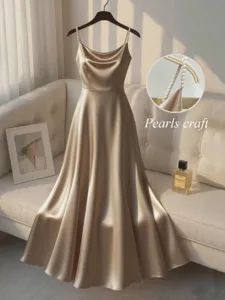 Elegant satin slip evening dress with handmade pearl straps, smooth shiny texture and fitted waist.