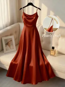 Elegant satin slip dress featuring pearl beaded straps, cowl neck and a flared A-line midi skirt.