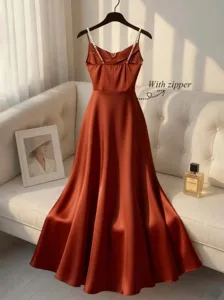 Elegant satin slip dress featuring pearl straps and flattering waist design for women.