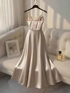 Elegant champagne satin slip dress for women with beaded straps and waist design.