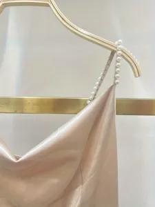 Elegant solid satin slip dress with handmade pearl straps, chic gilded finish for women.