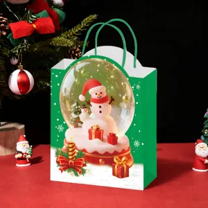 Detailed view of the Christmas gift paper bag featuring a festive snow globe snowman print.
