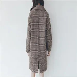 Back detail view of a stylish brown plaid long woolen overcoat for women, elegant winter style.