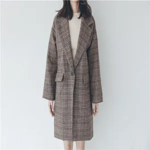 Detailed shot of women's brown plaid wool blend coat, casual winter outerwear style.