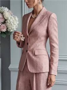 Detailed shot of stylish pink textured blazer suit with floral earrings, elegant look.