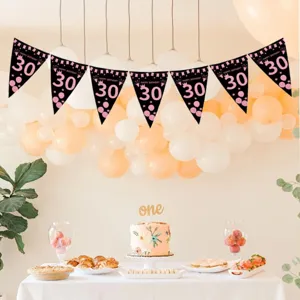 Detailed view of the 30th birthday black and pink triangle banner in a party setup.