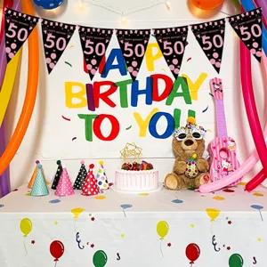 Detail shot of black and pink 50th birthday party triangle flags banner hanging setup.