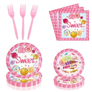 Ensemble de vaisselle de fête rose avec fourchettes serviettes et assiettes à motif bonbon