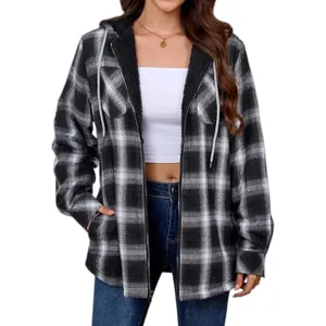 Close-up detail of women's black and white plaid fleece-lined hooded jacket fabric and zipper.