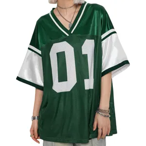 Detailed view of the loose patchwork jersey top with prominent number 01 print and V-neck.
