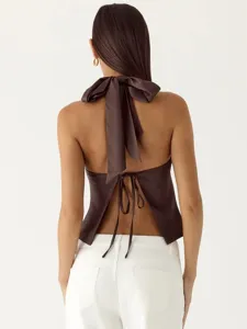 Satin halter backless crop top with bow tie detail, perfect for evening party wear and summer style.