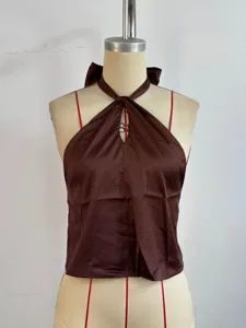 Detail view of the brown satin halter top, featuring a stylish crossover neckline and back tie.