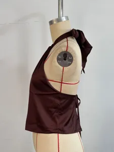 Detailed view of the dark brown satin halter top, showing the side profile and back tie.