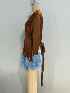 Detailed view of women's brown satin robe with light blue lace trim and waist belt sleepwear