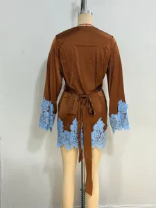 Detail view of brown satin women loungewear robe featuring delicate light blue lace trims.