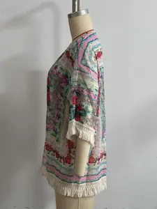 Close-up side view of floral print chiffon kimono cardigan featuring delicate fringe hem details.