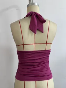 Close-up detail of the back design of a stylish purple halter top with adjustable tie neck.
